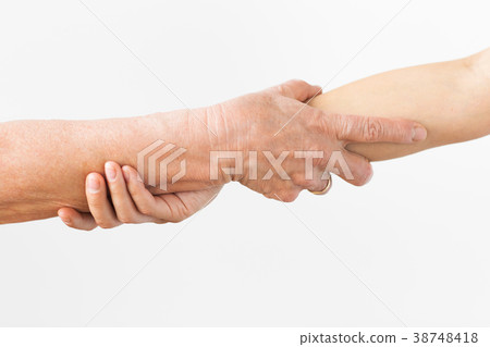 close up of senior and young woman holding hands close up of senior and young woman holding hands 38748418