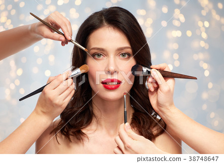 woman and hands of make up artists with brushes woman and hands of make up artists with brushes 38748647