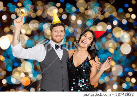 happy couple with party blowers having fun happy couple with party blowers having fun 38748928