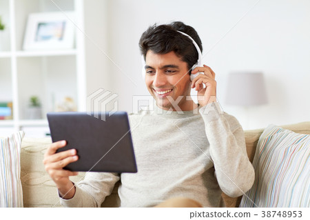 man in phones with tablet pc listening to music man in phones with tablet pc listening to music 38748953