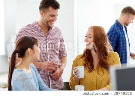 happy creative team drinking coffee at office happy creative team drinking coffee at office 38749198