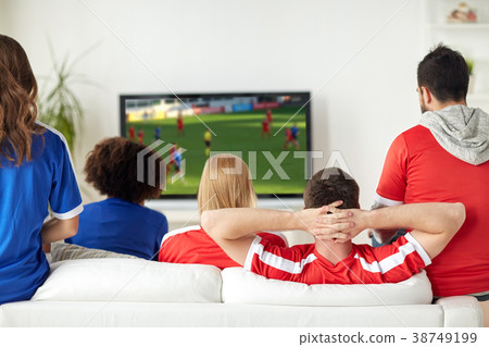 friends or soccer fans watching game on tv at home friends or soccer fans watching game on tv at home 38749199