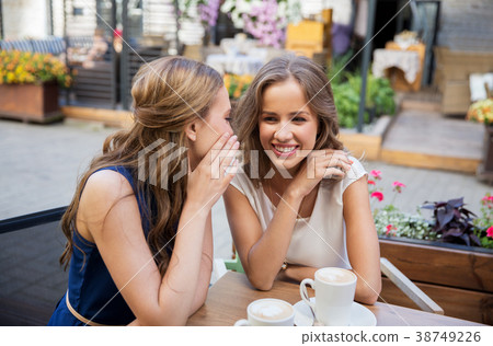 happy young women drinking coffee at outdoor cafe happy young women drinking coffee at outdoor cafe 38749226