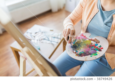 artist with palette knife painting at art studio artist with palette knife painting at art studio 38749426