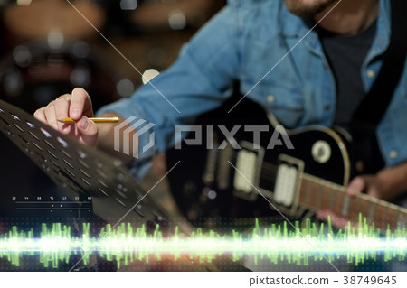 musician with guitar and music book at studio 38749645
