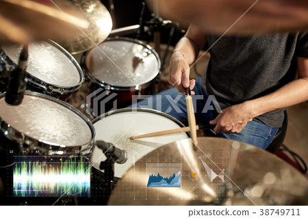 male musician playing drum kit at concert 38749711