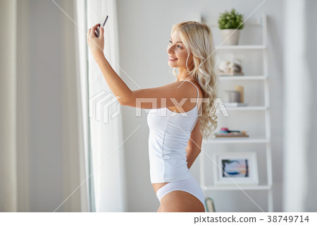 woman taking selfie by smartphone in morning 38749714