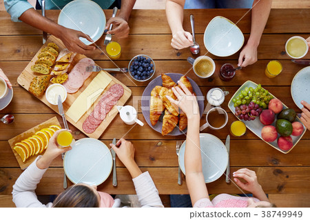 group of people having breakfast at table group of people having breakfast at table 38749949