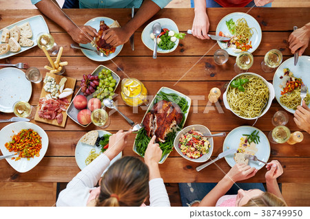 group of people eating chicken for dinner 38749950