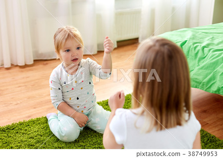 girls playing rock-paper-scissors game at home girls playing rock-paper-scissors game at home 38749953