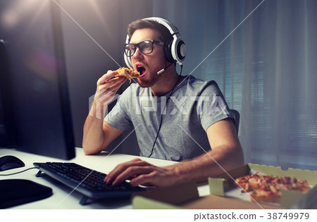 man in headset playing computer video game at home man in headset playing computer video game at home 38749979
