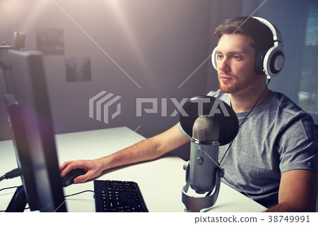 man in headset playing computer video game at home 38749991
