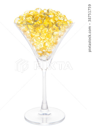 Fish oil capsule in cocktail glass with path  38751759