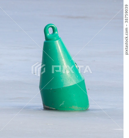 Green buoy in a large pond 38759039