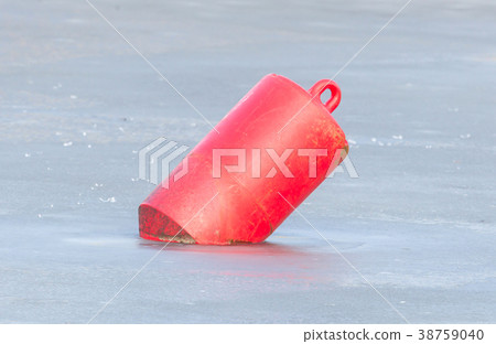Red buoy in a large pond 38759040