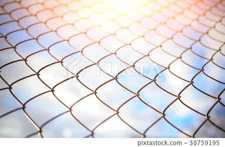 Blue sky behind a metal grate 38759195