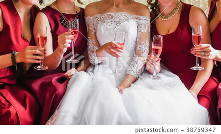 bride and happy girlfriends with glasses of wine bride and happy girlfriends with glasses of wine 38759347