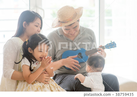Asian family playing ukulele Asian family playing ukulele 38759435