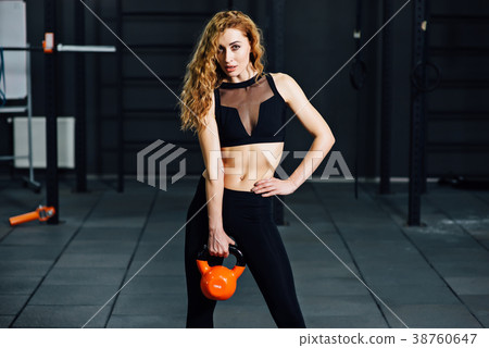 young athletic girl doing exercises in the gym 38760647