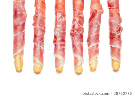 Bread sticks grissini with prosciutto isolated on 38760776