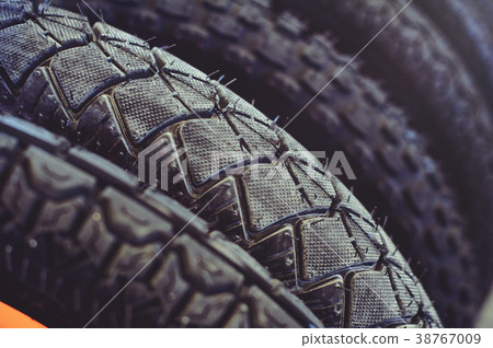 The tires on the bicycle wheel are in a row. The tires on the bicycle wheel are in a row. 38767009