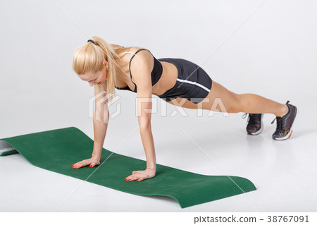 woman does exercises on fitness Mat woman does exercises on fitness Mat 38767091