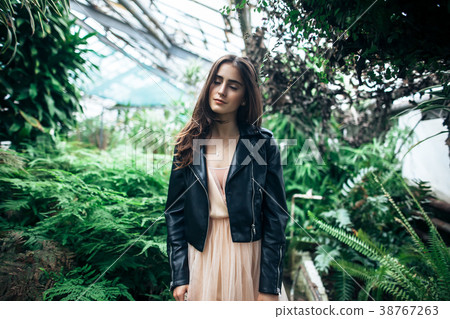 Beautiful dreaming woman with closed eyes posing in garden green Beautiful dreaming woman with closed eyes posing in garden green 38767263