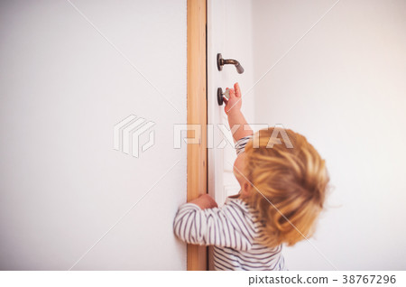 Toddler boy in a dangerous situation at home. 38767296