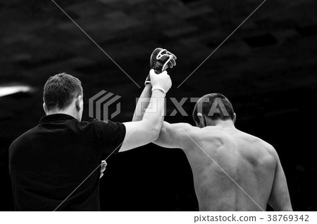 referee lifting hand of winner fighter referee lifting hand of winner fighter 38769342