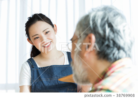 A woman working in a cafe A woman working in a cafe 38769908