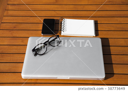 notepad with mobile phone, laptop and glasses notepad with mobile phone, laptop and glasses 38773649