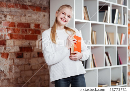 Teenage girl in a library Teenage girl in a library 38773781