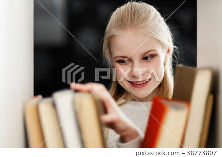 Teenage girl in a library Teenage girl in a library 38773807