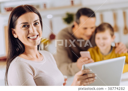 Upbeat woman posing with tablet in the kitchen 38774282