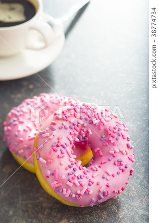 Two pink donuts. 38774734