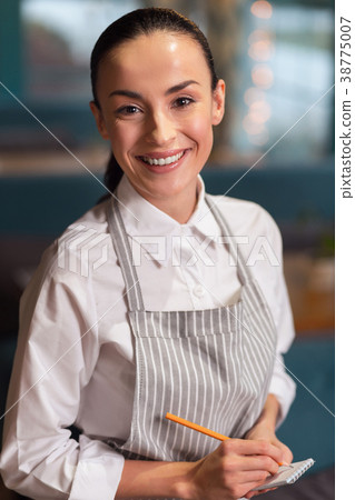 Skillful attractive waitress receiving order 38775007
