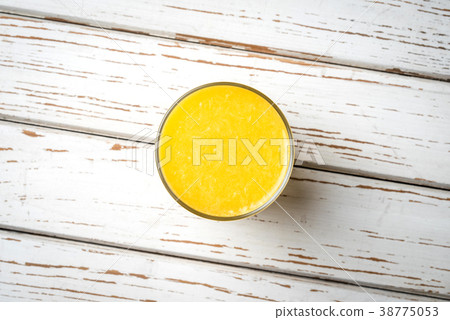 Orange juice on white wooden table 38775053