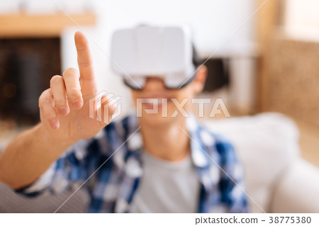 Smiling adolescent wearing a VR headset 38775380
