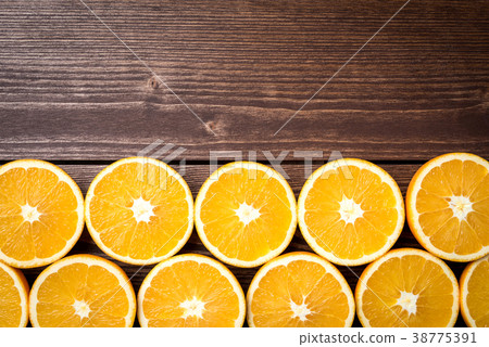 Half cut oranges on an old wooden table Half cut oranges on an old wooden table 38775391