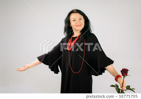 Lovely brunette in a black dress. The skirt 38775705