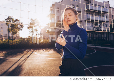 girl in blue sweater posing on sports field girl in blue sweater posing on sports field 38775887