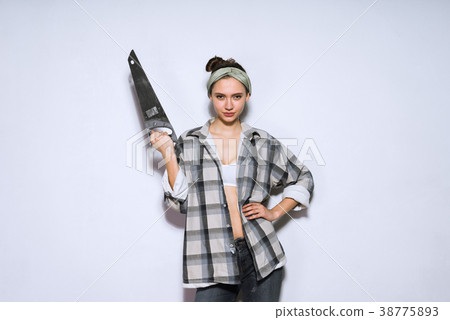girl builder holding in hands a sharp metal saw girl builder holding in hands a sharp metal saw 38775893