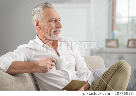 Relaxed pensioner drinking tasty coffee 38776058
