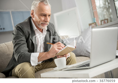 Concentrated businessman looking at his laptop Concentrated businessman looking at his laptop 38776059