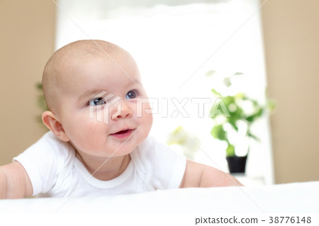 Happy newborn baby girl smiling 38776148