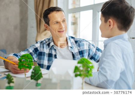 Pleasant man telling his son about his eco-city 38776174