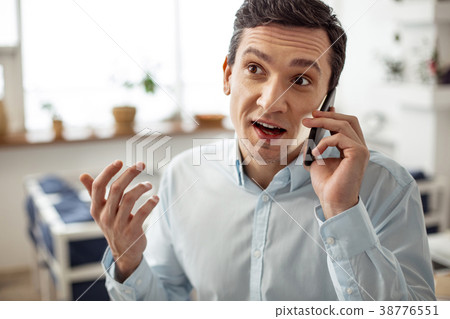 Inspired businessman discussing work with his Inspired businessman discussing work with his 38776551