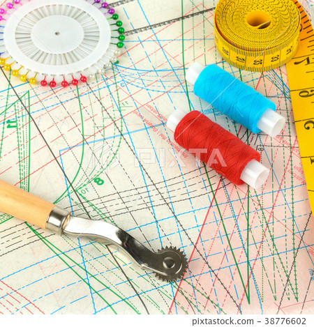 Background of sewing supplies and paper patterns. Background of sewing supplies and paper patterns. 38776602