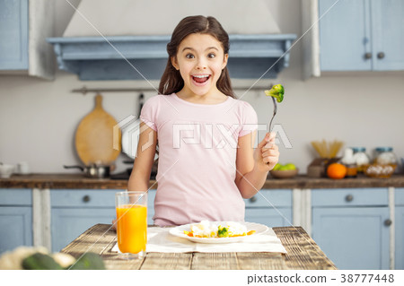 Delighted girl and having healthy breakfast Delighted girl and having healthy breakfast 38777448