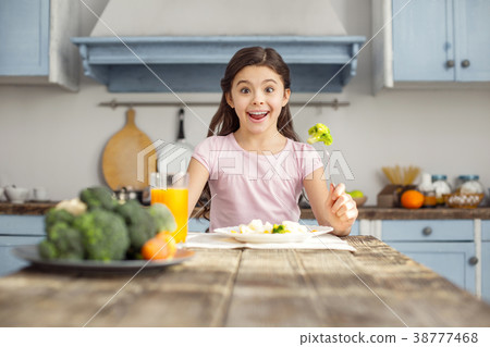 Smiling girl and having healthy breakfast Smiling girl and having healthy breakfast 38777468